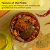 Texture of FarmDidi's Homemade Avakaya Pickle coated in masala with garlic pieces