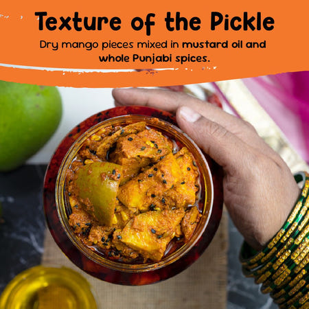 Close-up of Punjabi mango pickle texture with dry raw mango pieces in mustard oil and whole spices