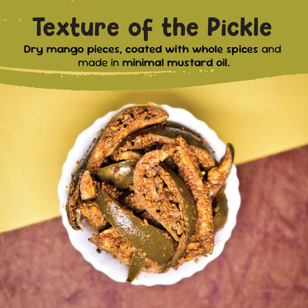 Close-up of dry mango pickle with mango slices coated in whole spices and minimal mustard oil